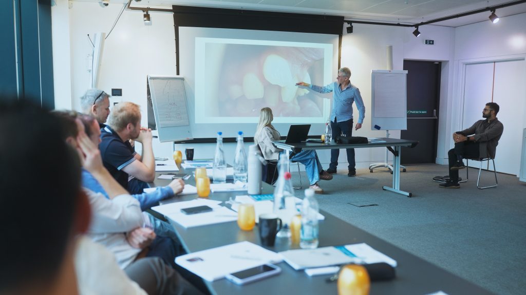 delegates engaged in learning during lecture on identiti PG diploma course for orthodontics, still from promotional video