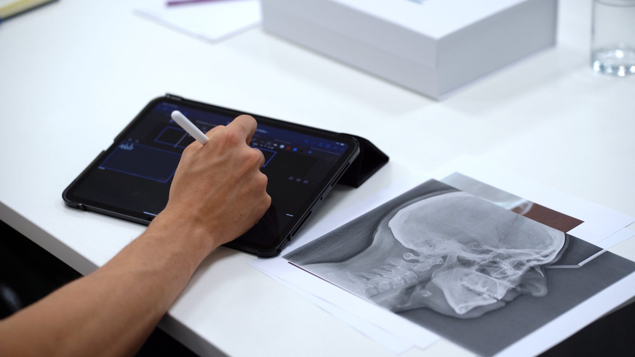 man using an ipad to write notes