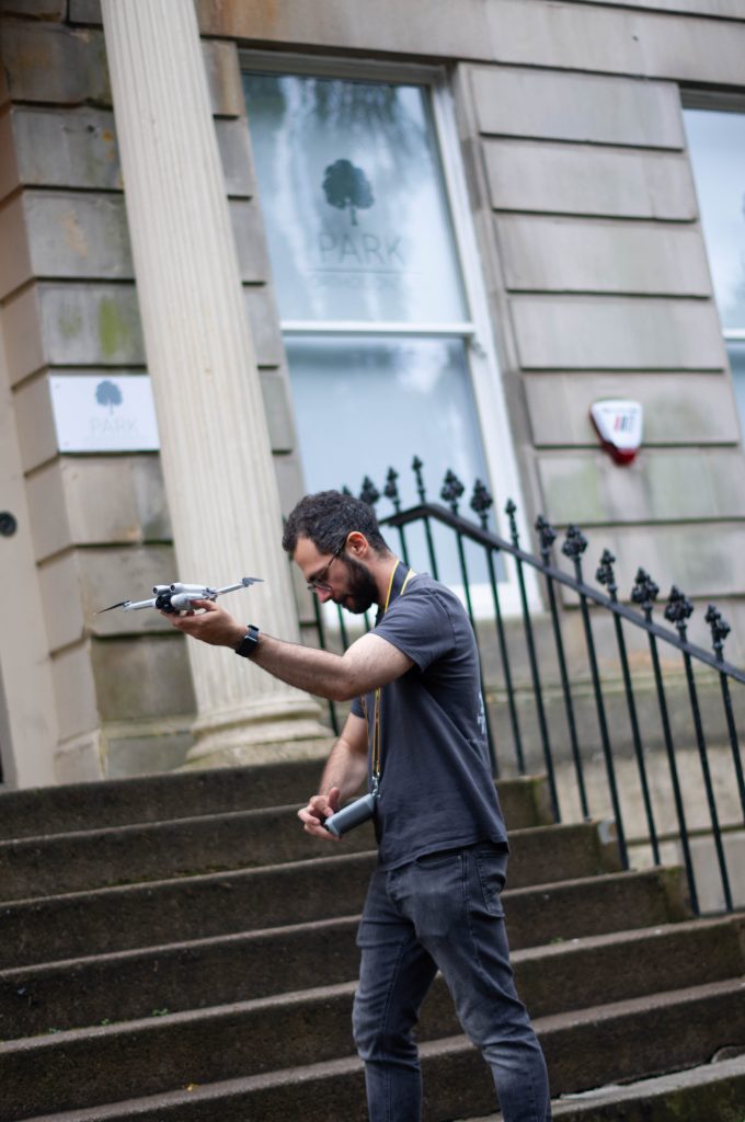 man flying drone for promotional video in glasgow, scotland