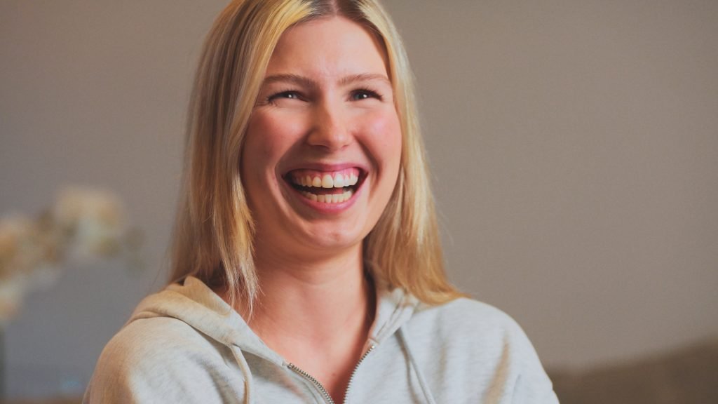 a woman smiling during the filming of a testimonial case study video for an orthodontics clinic
